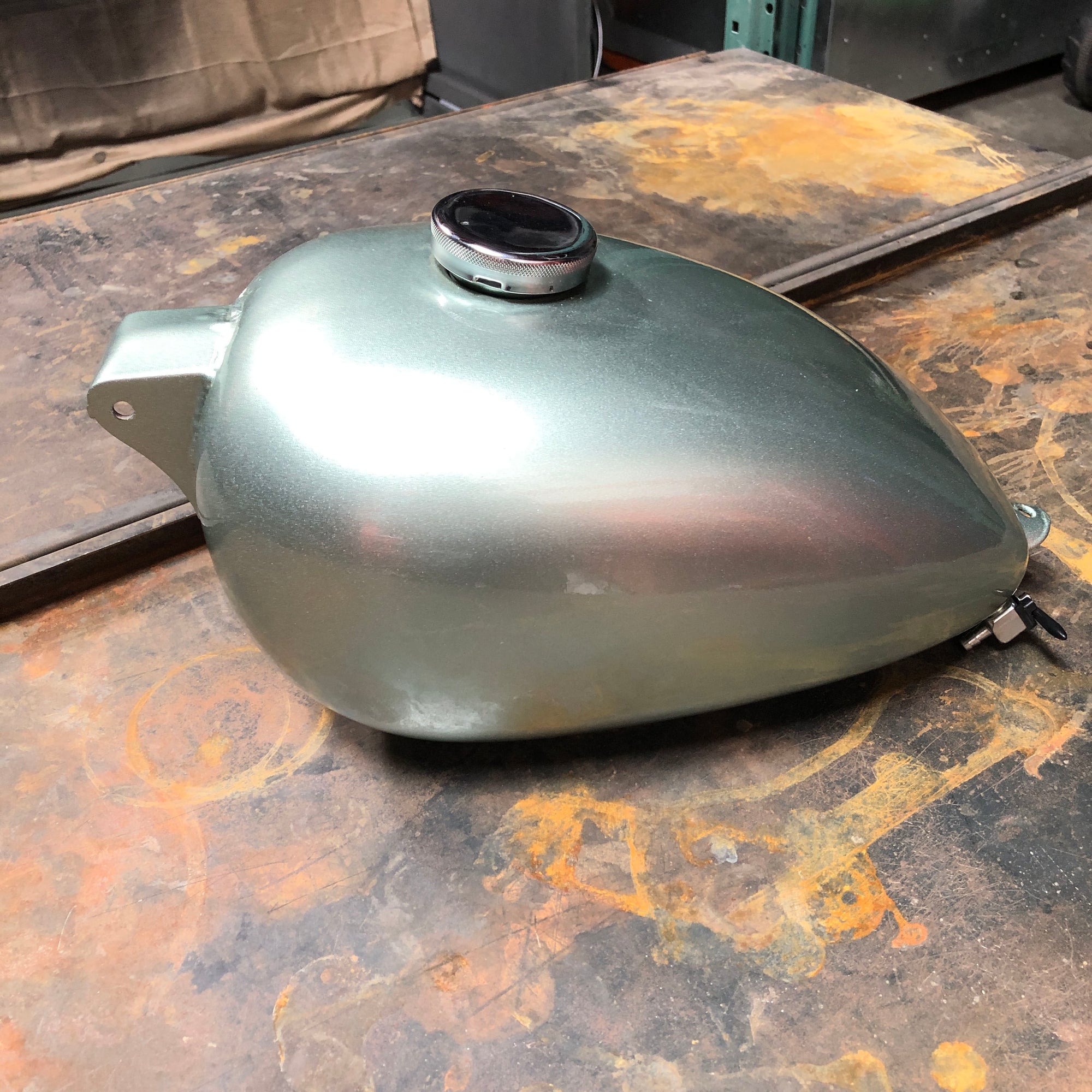 Stripping custom Harley Davidson gas tank in preparation for paint.